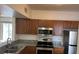 Modern kitchen with stainless steel appliances, granite countertops, and wood cabinetry at 6011 Skydale Way # 101, Riverview, FL 33578