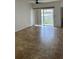 Open living room area with tile flooring and sliding glass doors leading to outdoor space at 6011 Skydale Way # 101, Riverview, FL 33578