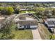 A beautiful overhead view of the home with an enclosed pool, fenced yard, and an expansive grassy front yard at 6333 Spanish Main Dr, Apollo Beach, FL 33572