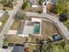 Aerial view of a property featuring a screened pool, fenced yard and proximity to roads and other homes at 6333 Spanish Main Dr, Apollo Beach, FL 33572