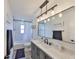 Updated bathroom with modern lighting fixture and vanity, shower and tub combo, and neutral colors at 6333 Spanish Main Dr, Apollo Beach, FL 33572