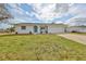 Charming single-story home featuring a well-manicured lawn and an attached garage with driveway at 6333 Spanish Main Dr, Apollo Beach, FL 33572