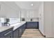 Galley kitchen boasting white countertops, two-tone cabinetry, and stainless appliances at 6333 Spanish Main Dr, Apollo Beach, FL 33572