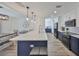 Modern kitchen with a large center island, pendant lighting, and stainless steel appliances at 6333 Spanish Main Dr, Apollo Beach, FL 33572