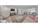 Spacious living room features wood floors, a large area rug and an open floor plan at 6333 Spanish Main Dr, Apollo Beach, FL 33572