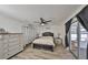 Cozy main bedroom with ceiling fan, sliding glass doors to the patio, and two nightstands at 6333 Spanish Main Dr, Apollo Beach, FL 33572