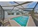 Covered pool provides a refreshing retreat with ample space for swimming and lounging outdoors at 6333 Spanish Main Dr, Apollo Beach, FL 33572