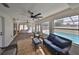 Bright sunroom with tile flooring, wicker furniture, and scenic views of the outdoor pool at 6333 Spanish Main Dr, Apollo Beach, FL 33572