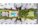 Overhead view of condo buildings with the community pool, shuffleboard courts, and landscaping at 6960 20Th N Ave # 405, St Petersburg, FL 33710