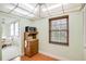 Cozy eat-in kitchen nook area with wood cabinets, microwave and window with natural light and view at 6960 20Th N Ave # 405, St Petersburg, FL 33710