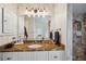 Bathroom featuring a granite countertop, decorative wallpaper, and a view of the tiled walk-in shower at 716 Samantha Dr, Palm Harbor, FL 34683