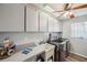 Laundry room with modern washer and dryer, ample cabinet space, and utility sink at 716 Samantha Dr, Palm Harbor, FL 34683