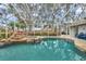 Screened pool area with hot tub and rock waterfall feature at 716 Samantha Dr, Palm Harbor, FL 34683