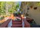 Exterior view of back porch with seating area and decorated with greenery, plants and an outdoor rug at 912 E 23Rd Ave, Tampa, FL 33605
