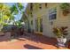 Inviting back porch featuring a seating area, bright yellow doors, plants and an outdoor rug at 912 E 23Rd Ave, Tampa, FL 33605
