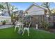 Charming back yard featuring a sitting area and beautiful greenery at 912 E 23Rd Ave, Tampa, FL 33605
