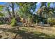Scenic back yard featuring a garden, a fountain and beautiful mature trees at 912 E 23Rd Ave, Tampa, FL 33605