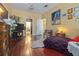 Comfortable bedroom offers hardwood floors, doorway to bathroom and view of stairs to create an appealing layout at 912 E 23Rd Ave, Tampa, FL 33605