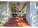 Wide front porch with decorative tile steps, white painted brick supports, and views of the home's facade at 912 E 23Rd Ave, Tampa, FL 33605