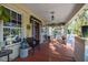 Inviting front porch with decorative plants, stylish furniture, and a relaxing atmosphere to enjoy the outdoors at 912 E 23Rd Ave, Tampa, FL 33605