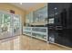 Elegant kitchen with stainless steel appliances and cabinetry leading to an outdoor patio at 912 E 23Rd Ave, Tampa, FL 33605