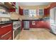 Bright kitchen with stainless steel appliances, custom cabinets, granite countertops, and marble tile flooring at 912 E 23Rd Ave, Tampa, FL 33605