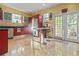Bright kitchen with stainless steel appliances and custom red cabinetry at 912 E 23Rd Ave, Tampa, FL 33605