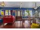 Spacious living room featuring hardwood floors, large windows, and comfortable seating creating an inviting space at 912 E 23Rd Ave, Tampa, FL 33605