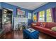 Cozy living room with a brick fireplace, hardwood floors, and comfortable sofa offers relaxation and charm at 912 E 23Rd Ave, Tampa, FL 33605