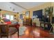 Open-concept living room featuring hardwood floors, eclectic decor, and comfortable seating arrangement at 912 E 23Rd Ave, Tampa, FL 33605