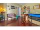 Cozy living room with hardwood floors, eclectic furniture, and a decorative spiral staircase at 912 E 23Rd Ave, Tampa, FL 33605
