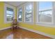 Bright sunroom featuring hardwood floors and tons of sunlight with a view to the outside at 912 E 23Rd Ave, Tampa, FL 33605