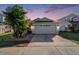 Charming single-story home featuring a two-car garage, manicured landscaping, and a well-maintained lawn at 9842 Edmonton Dr, Land O Lakes, FL 34638