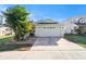 Well-maintained single-Gathering home with a large two-car garage and a neatly landscaped front yard at 9842 Edmonton Dr, Land O Lakes, FL 34638