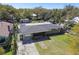 Aerial view of a single-story home with a flat roof, spacious yard, and detached garage or shed in the back at 200 W Louisiana Ave, Tampa, FL 33603