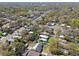 A distant aerial view of a neighborhood featuring mature trees, tree-lined streets, and a variety of single-Gathering homes at 200 W Louisiana Ave, Tampa, FL 33603
