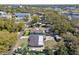 Aerial view of a single story home with a large yard, sheds, and mature trees in a neighborhood setting at 200 W Louisiana Ave, Tampa, FL 33603