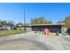 View of a backyard and concrete patio with an enclosed porch, toys, and a detached garage at 200 W Louisiana Ave, Tampa, FL 33603