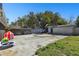 View of a concrete patio with a small trampoline, tent, and a detached garage at 200 W Louisiana Ave, Tampa, FL 33603
