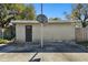 Exterior of the back of the house and backyard area with a basketball hoop at 200 W Louisiana Ave, Tampa, FL 33603