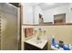 Small bathroom with shower, sink and toilet. The tiled area needs some TLC at 200 W Louisiana Ave, Tampa, FL 33603