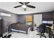 A bedroom with tile floor, closet door, desk and a light brown window blind at 200 W Louisiana Ave, Tampa, FL 33603