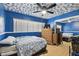 Blue bedroom with bed, dresser, mirrored closet doors and decorated ceiling at 200 W Louisiana Ave, Tampa, FL 33603