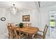 Elegant dining room with chandelier and wood table set for six, perfect for entertaining at 200 W Louisiana Ave, Tampa, FL 33603