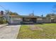 A single-story home with a well-maintained lawn and paved driveway at 200 W Louisiana Ave, Tampa, FL 33603