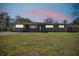 A single-story home with a well-maintained lawn at dusk at 200 W Louisiana Ave, Tampa, FL 33603