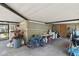 View of an indoor garage with bicycles, cleaning machines, tools, and storage on concrete flooring at 200 W Louisiana Ave, Tampa, FL 33603