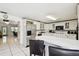 Open kitchen with breakfast bar, stainless steel appliances, and convenient access to other living areas at 200 W Louisiana Ave, Tampa, FL 33603