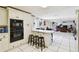 Traditional kitchen with breakfast bar open to living area, featuring black appliances and tile flooring at 200 W Louisiana Ave, Tampa, FL 33603