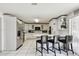 Well-equipped kitchen with white cabinetry, stainless steel appliances, and a breakfast bar at 200 W Louisiana Ave, Tampa, FL 33603
